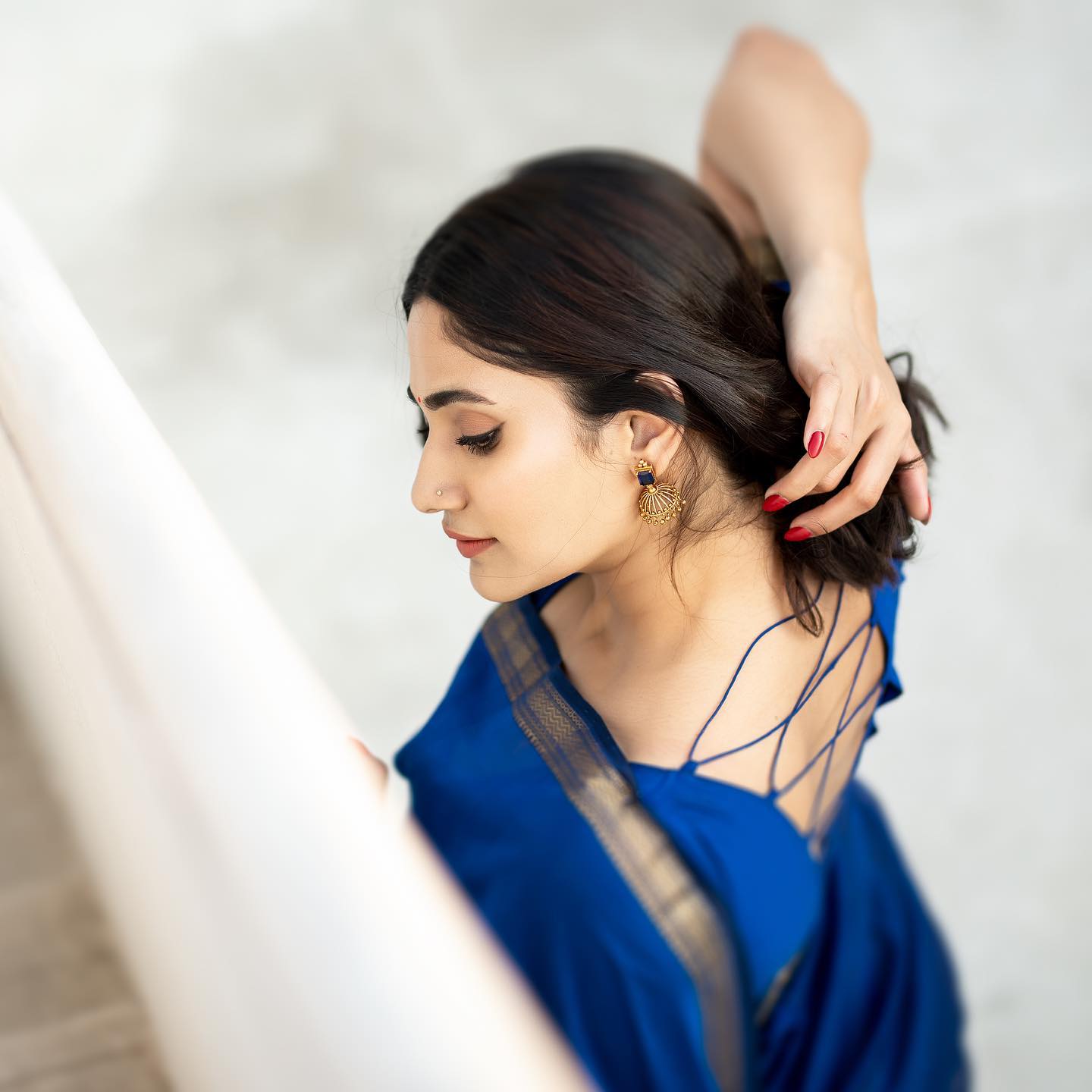 Losliya hot photos in blue colour saree and back open blouse
