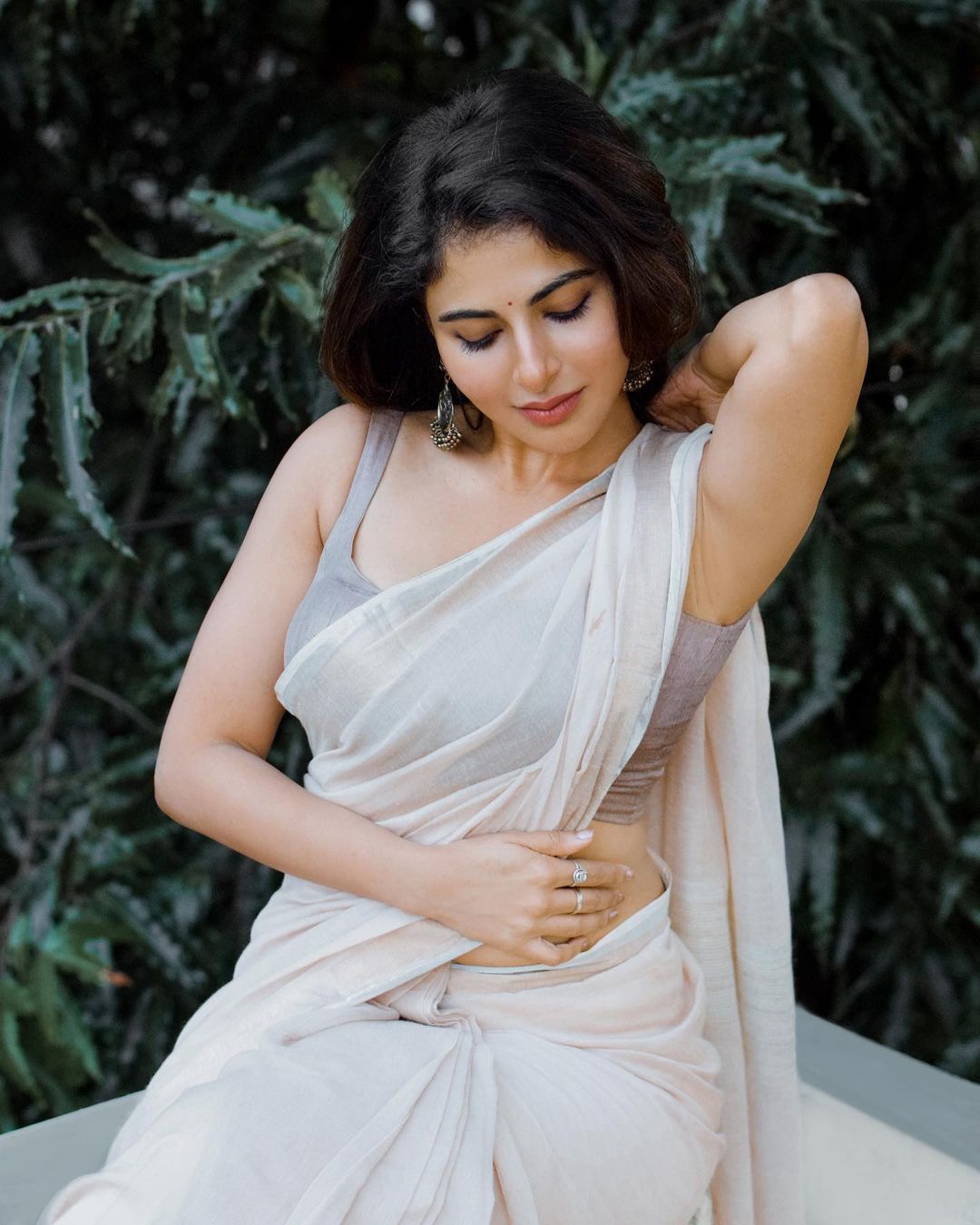 Iswarya menon hot photos in white transparent saree showing hip