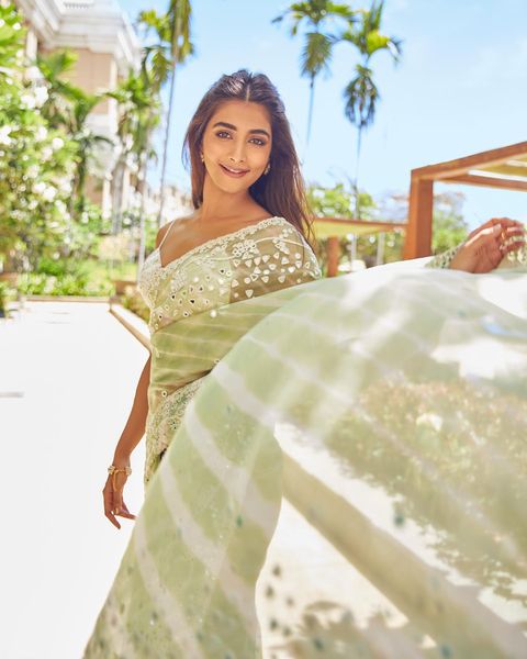 Pooja hegde hot photoshoot in transparent saree and low neck blouse
