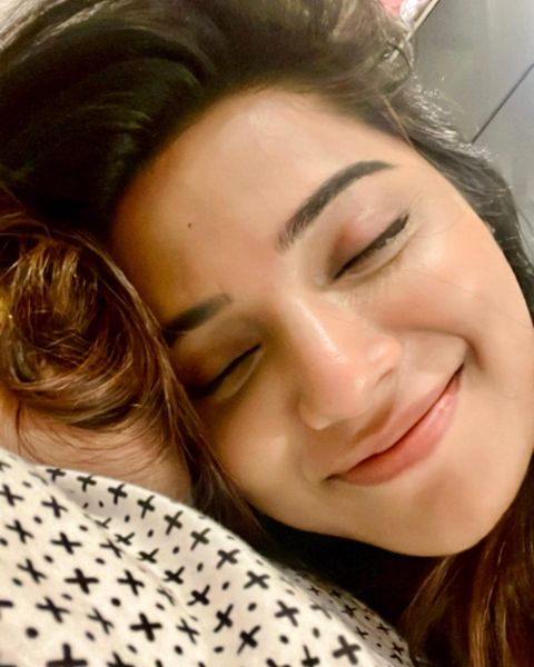 Aathmika hot photos in close up expressions on bed